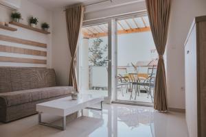 a living room with a couch and a table at Poolside Hideout Apartments in Novalja