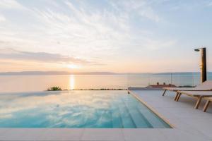 a swimming pool with a view of the water at Villa rOvni by IstriaLux in Ravni