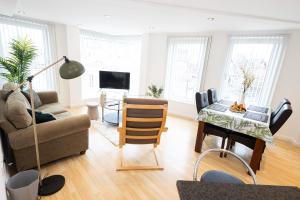 a living room with a couch and a table at Withington Apartments- Wilmslow Road- Free Parking in Manchester