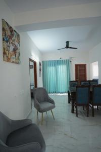 a living room with a couch and chairs and a table at Yellow Bells Serviced Apartments Hitech City in Hyderabad