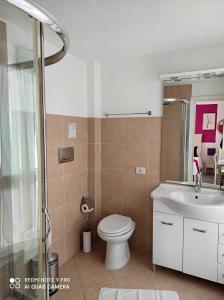 a bathroom with a toilet and a sink and a shower at B&B Domus de Janas Santa Teresa Gallura in Santa Teresa Gallura