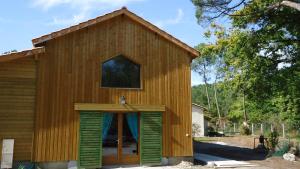 a small wooden building with a large door at HERMITAGE MARMANDAIS in Anzex