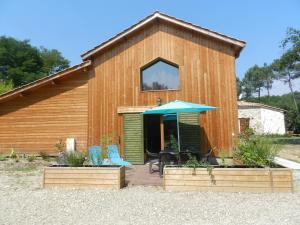 a house with two chairs and an umbrella at HERMITAGE MARMANDAIS in Anzex +10 photos
