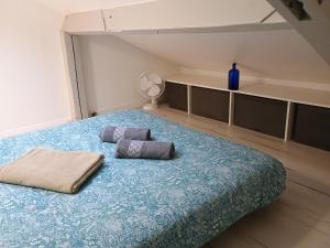 a bedroom with a bed with two pillows on it at Proche Paris,Cosy appartement, 3 bedrooms in Saint-Ouen