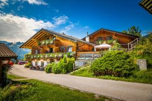 a wooden house with a pathway in front of it at Gasthof Pesbichl in Goldegg