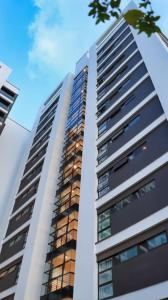 a tall building with windows on the side of it at Astoria Apartments Lovely One Bedroom Apartment With AC & UPS in Lavington in Nairobi