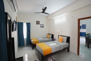 a bedroom with two beds and a window at Yellow Bells Serviced Apartments Hitech City in Hyderabad