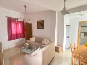 a living room with a couch and a table at Casa Encina in Torremolinos