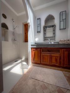 a bathroom with a sink and a shower at Maidan El Arsa in Oulad Mazoug