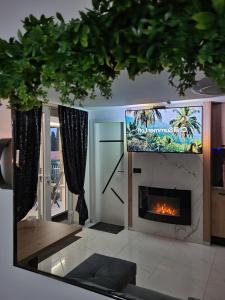 a living room with a fireplace and a tv at Adriatic SPA Apartment in Selce