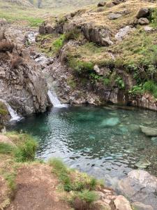 a pool of water in a river with a waterfall at Burnthwaite Farm B&B 