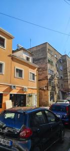a black car parked in front of some buildings at Library Apartment by Bohem Rentals in Durrës