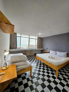a bedroom with two beds and a checkered floor at The 60 in George Town