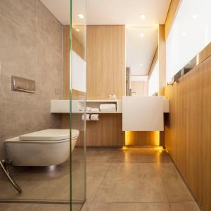 a bathroom with a toilet and a sink at Ad Lib Hotel Bangkok in Bangkok