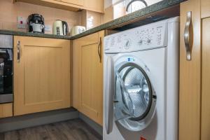 a white washer and dryer in a kitchen at Reading 2-Bed Apartment & Parking in Caversham