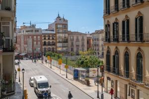 a city street with a van driving down a street at Victoria 16 Premium by Nagoa Homes in Málaga