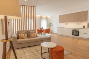 a living room with a couch and a table at Ana's Apartments in Sines