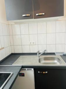a kitchen with a sink and a counter top at Wohnung im Herzen der Stadt ,Nähe Stadion. in Dortmund