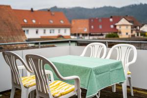 a table and chairs on a balcony with a view at Ferienwohnung Smithson in Biberach