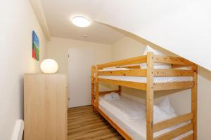 a bunk bed in a room with a staircase at Strandschloesschen-I-WE-21-684 in Kühlungsborn