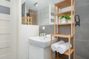 a bathroom with a sink and a mirror at Cosy Ariańska Apartment for 3 in Cracow Center by Renters in Krakow