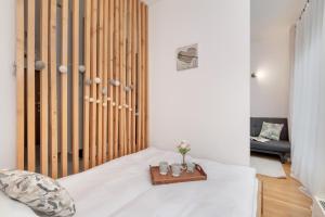 a bedroom with a bed with a wooden headboard at Cosy Ariańska Apartment for 3 in Cracow Center by Renters in Krakow