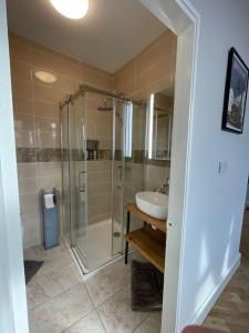 a bathroom with a glass shower and a sink at Newly Refurbished 1 Bed Flat Southsea in Portsmouth