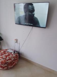 a flat screen tv hanging on a wall with a pillow at One bedroom holiday home malindi in Malindi