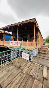 a wooden pier with a building on top of it at Aliflaila Laila Group of Houseboats , Srinagar in Srinagar