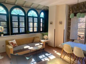 a living room with a couch and a table at Apartamentos Hevia in Villaviciosa