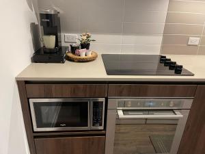 a kitchen with a microwave and a coffee maker at Family INN in Vaughan