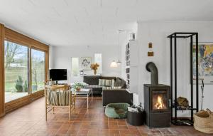 a living room with a fireplace and a couch at Lovely Home In Mern With Wifi in Mern