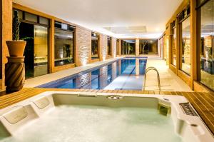a bath tub in a house with a swimming pool at Solar Mirador Exclusive Resort e SPA in Praia do Rosa
