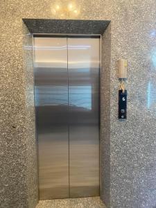SAIGON - PLEIKU HOTEL في بلاي كو: مصعد معدني في مبنى به جدار