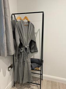a robe hanging on a rack in a closet at Glenariff Forest Redwood Lodge in Glenariff