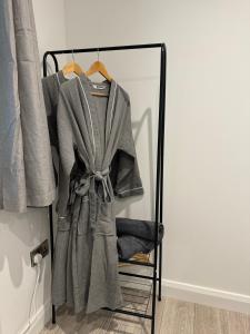 a robe hanging on a rack in a closet at Glenariff Forest Redwood Lodge in Glenariff +5 photos