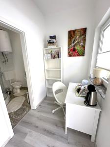 a white room with a table and a chair at OM Yoga center in Slovenska Bistrica