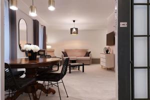 a living room with a table and a couch at 4BNB - Ponte Milvio Apartment in Rome