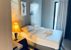 a bedroom with a bed with two towels on it at The Green Plaza Hotel in Bangrak Beach