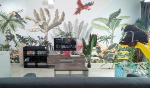 a living room with a tropical mural on the wall at Titiwangsa Monorial MRT LRT Station to Bukit Bintang Pavilion playground WTC HKL in Kuala Lumpur