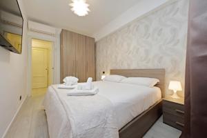 a bedroom with a large bed with towels on it at 4BNB - Ponte Milvio Apartment in Rome