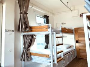a bunk bed in a tiny house at OYO 75471 Better Zzz in Bangkok