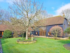 a tree in the yard of a house at Sussex Barns - Horsham in Horsham