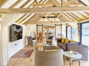 a living room with couches and a table at Sussex Barns - Horsham in Horsham