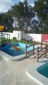 un parque infantil con un tobogán y un tobogán en MY HOTEL AL YAQOT 3 POOLS VILLA - NIZWA, en Nizwa
