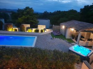 a villa with a swimming pool at night at Le cocon in Lussas