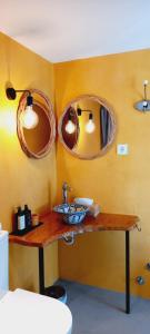 a bathroom with a sink and two mirrors on the wall at Monte da Urze Aljezur in Aljezur