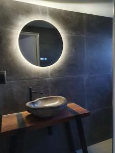 a bathroom with a bowl sink and a mirror at Nature Zeeland in Lamswaarde