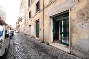 a street with cars parked next to a building at Studio Flat - Lungara 44A in Rome