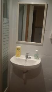 a bathroom with a white sink and a mirror at Coliving 54 Buhardilla Numero 3 in El Arrabal